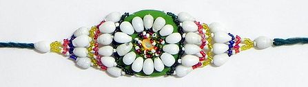 White and Multicolor Beaded Armlet on Green Cloth