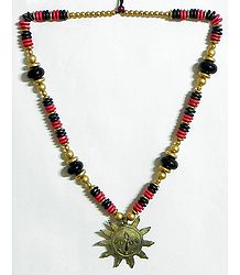 Beaded Tibetan Necklace with Antiqueted Dhokra Sun Pendant